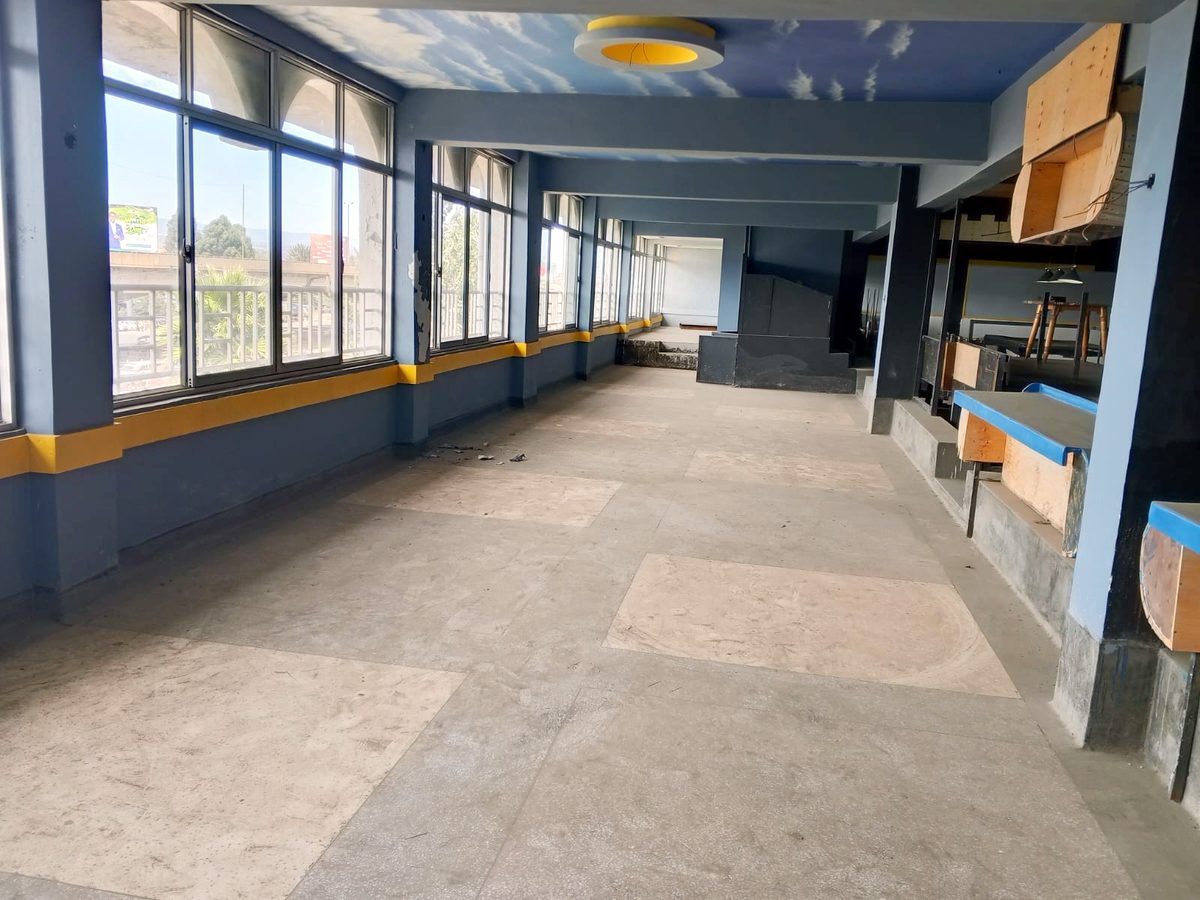 A daylit corridor with windows onto Nakuru